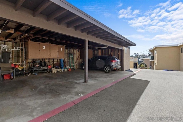 view of parking / parking lot featuring a carport