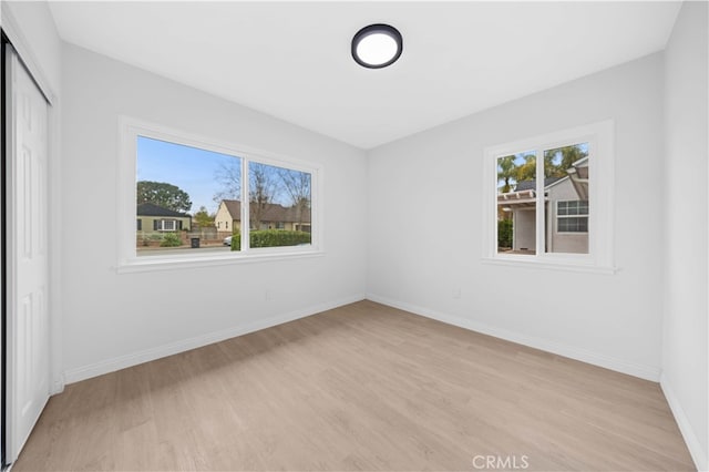 unfurnished bedroom with a closet and light wood-type flooring