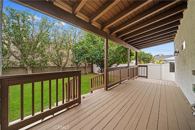 wooden terrace with a lawn