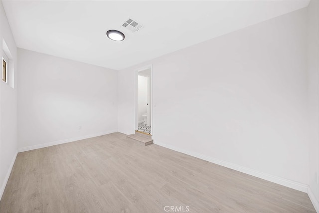 spare room featuring light wood-type flooring