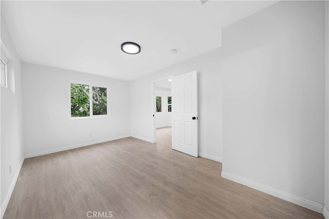 empty room with light hardwood / wood-style floors