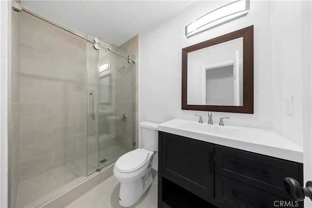 bathroom with a shower with door, vanity, and toilet