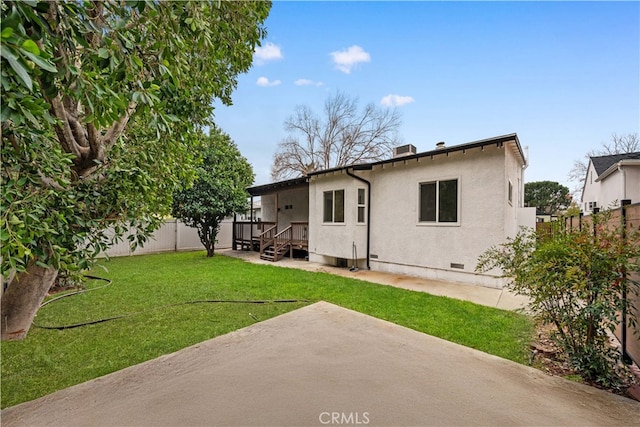 rear view of house with a yard and a patio