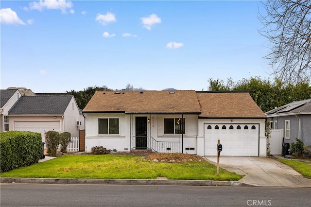 ranch-style house featuring a garage and a front lawn