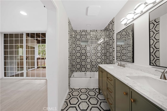 bathroom featuring vanity and tiled shower / bath