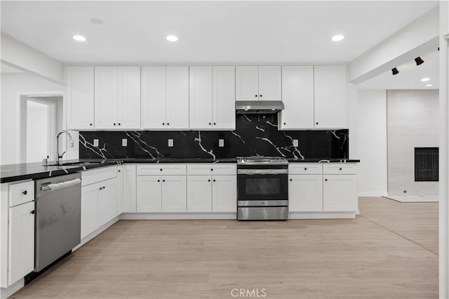 kitchen with white cabinetry, sink, stainless steel appliances, and light wood-type flooring