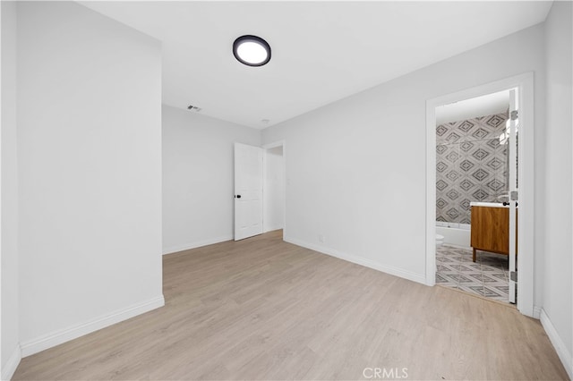 spare room featuring light wood-type flooring