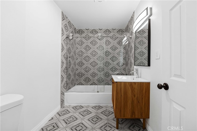 full bathroom featuring vanity, toilet, tiled shower / bath combo, and tile patterned flooring