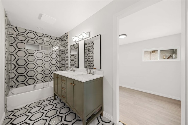 bathroom featuring tiled shower / bath and vanity