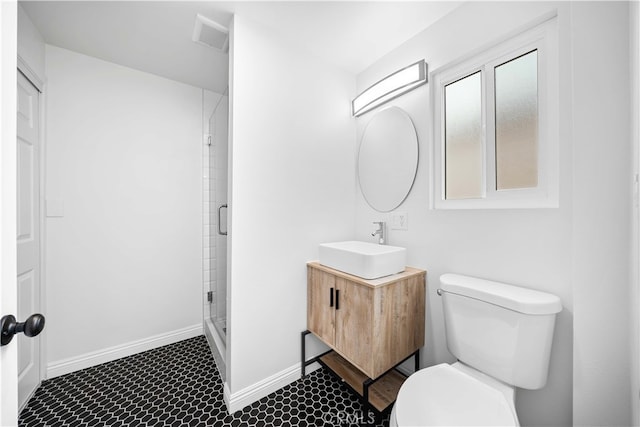 bathroom with an enclosed shower, vanity, and toilet