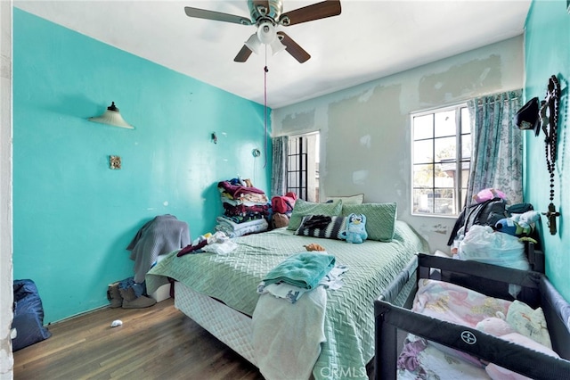 bedroom featuring wood-type flooring and ceiling fan