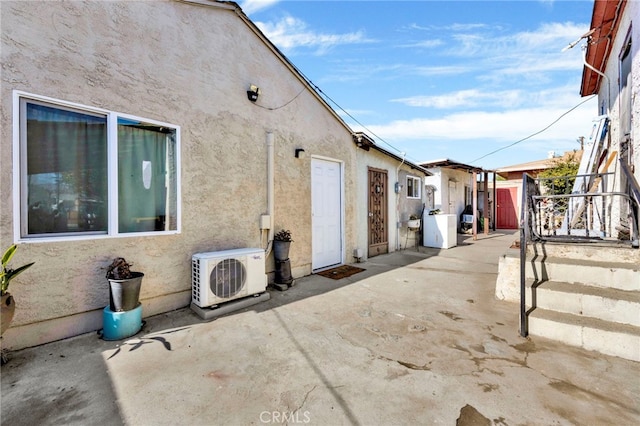 view of side of home with ac unit and a patio area