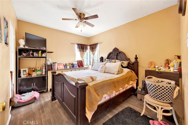 bedroom featuring wood-type flooring and ceiling fan