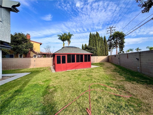 view of yard featuring a fenced backyard and an outdoor structure