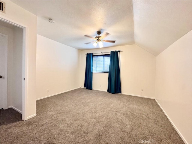 unfurnished bedroom featuring lofted ceiling, carpet flooring, and baseboards