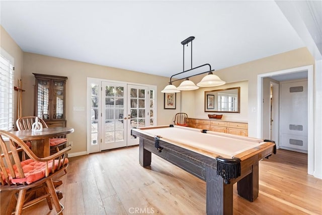 recreation room featuring billiards, light hardwood / wood-style floors, and french doors