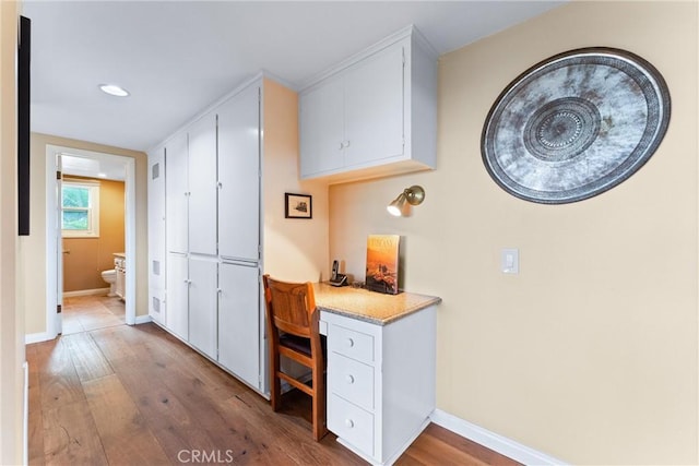 hall with hardwood / wood-style floors