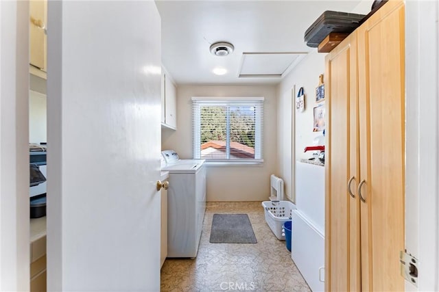 washroom featuring washer and clothes dryer and cabinets