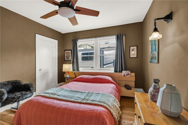 bedroom featuring hardwood / wood-style floors and ceiling fan