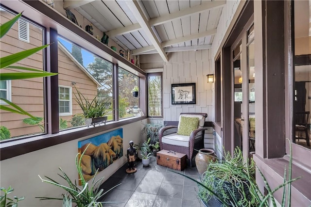 sunroom / solarium featuring beamed ceiling and wood ceiling