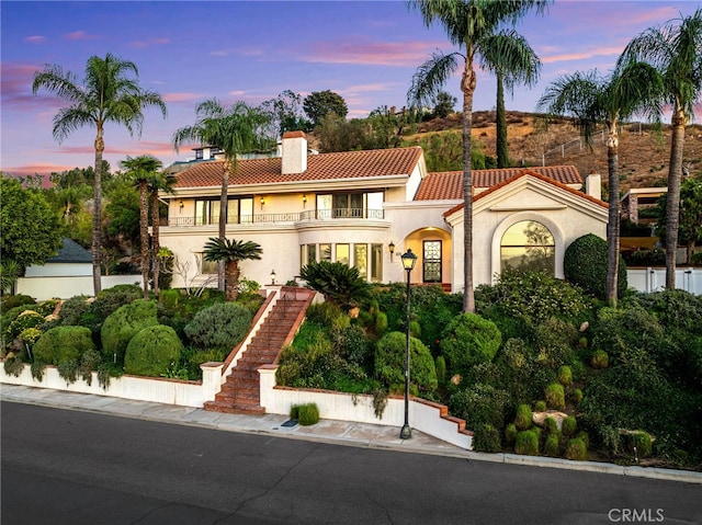 mediterranean / spanish-style home featuring a balcony