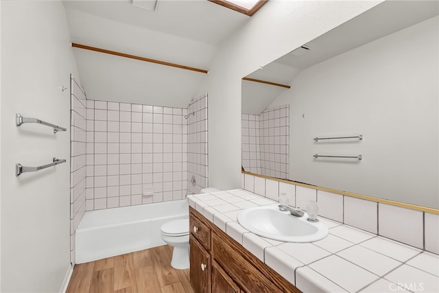 2572 Sunset Dr, Riverside, CA 92506 - full bathroom with lofted ceiling, toilet, vanity, tiled shower / bath combo, and hardwood / wood-style floors