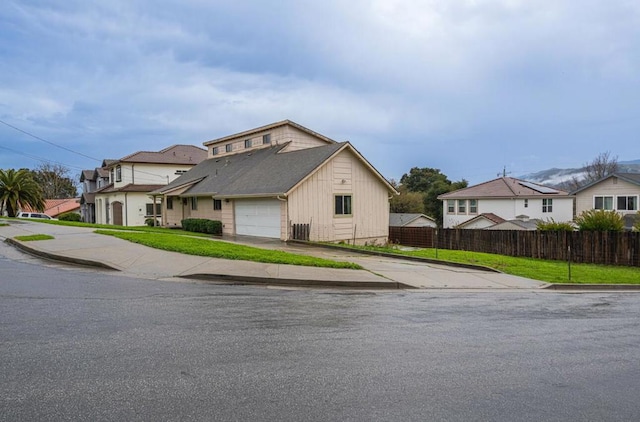 view of front of property with cooling unit, a garage, and a front yard