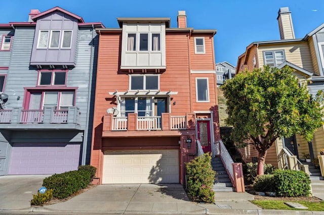 multi unit property featuring a balcony and a garage