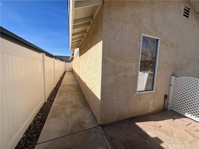 view of side of property featuring a patio area