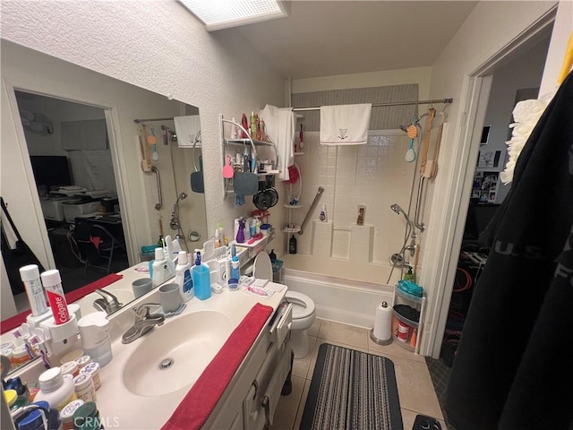 full bathroom featuring tile patterned flooring, vanity, toilet, and  shower combination