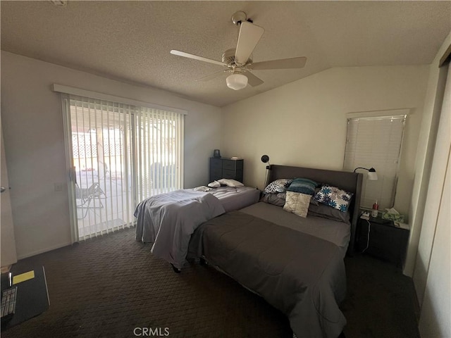 bedroom featuring lofted ceiling, ceiling fan, access to exterior, dark colored carpet, and a textured ceiling