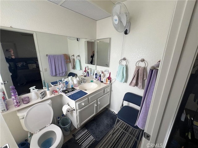 bathroom featuring vanity and toilet