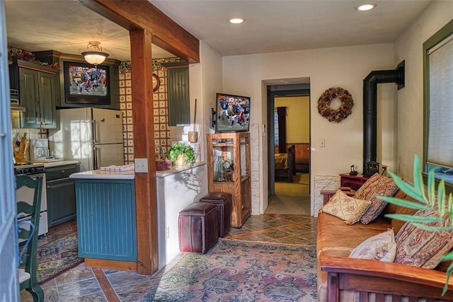 kitchen with a wood stove and white appliances