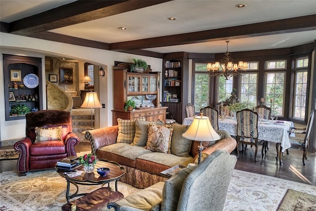 living room featuring an inviting chandelier, wood-type flooring, and beamed ceiling