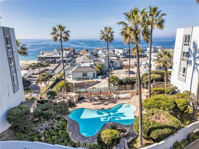 view of swimming pool featuring a patio area and a water view