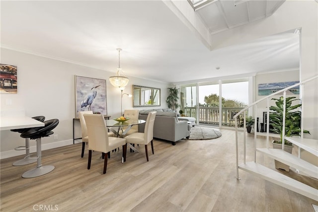 dining space featuring ornamental molding and light wood-type flooring