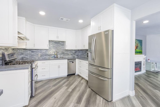 kitchen featuring light wood-type flooring, appliances with stainless steel finishes, sink, and white cabinets