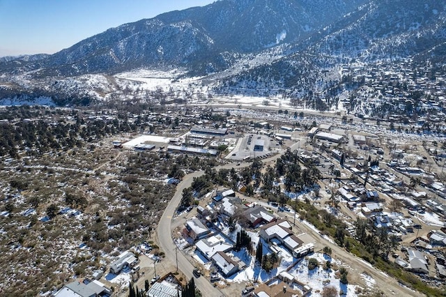 snowy aerial view with a mountain view