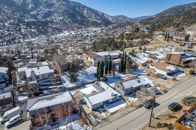 snowy aerial view featuring a mountain view