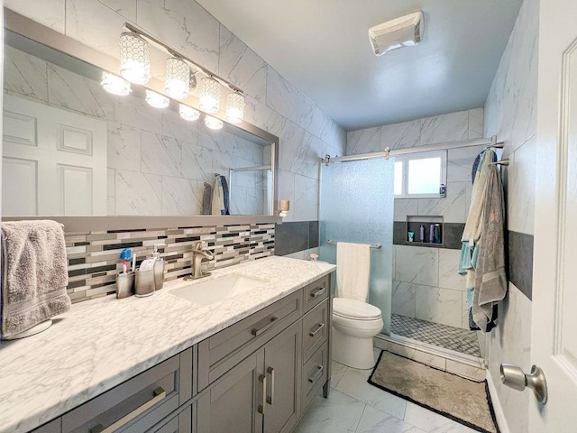 bathroom featuring tile walls, backsplash, an enclosed shower, vanity, and toilet