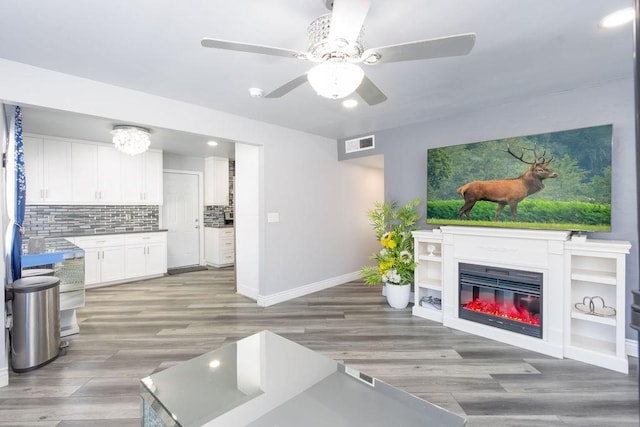 living room with hardwood / wood-style flooring and ceiling fan