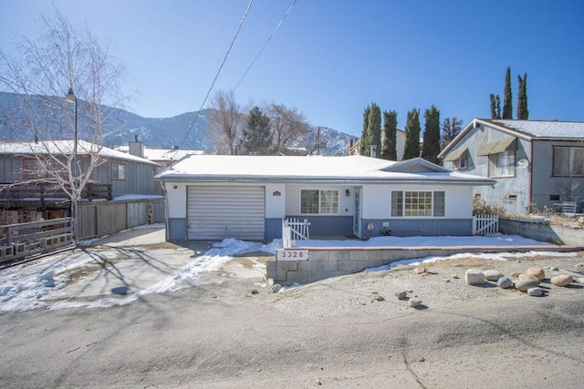 view of front of house featuring a garage and a mountain view