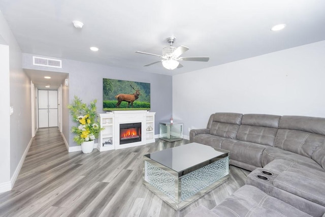 living room featuring ceiling fan and light wood-type flooring