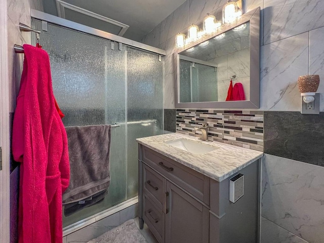 bathroom featuring an enclosed shower, vanity, and backsplash