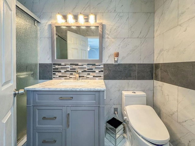 bathroom with vanity, toilet, and a shower with door