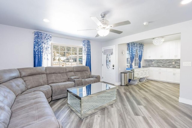 living room featuring ceiling fan and light hardwood / wood-style floors