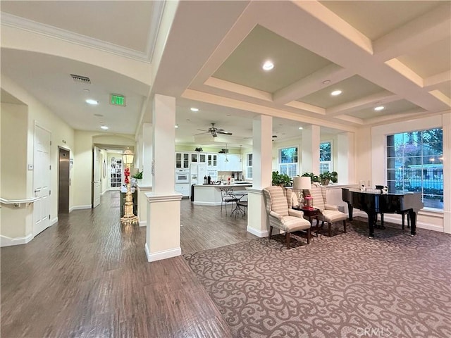 living room with crown molding, dark wood-type flooring, ceiling fan, beam ceiling, and coffered ceiling