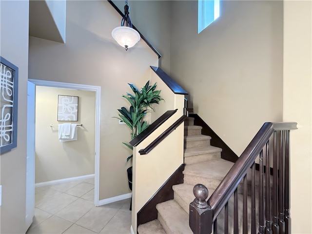 stairway featuring tile patterned flooring