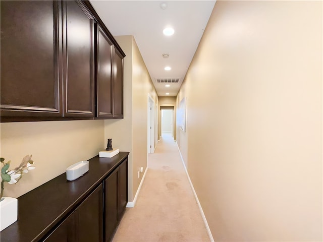 corridor featuring light colored carpet