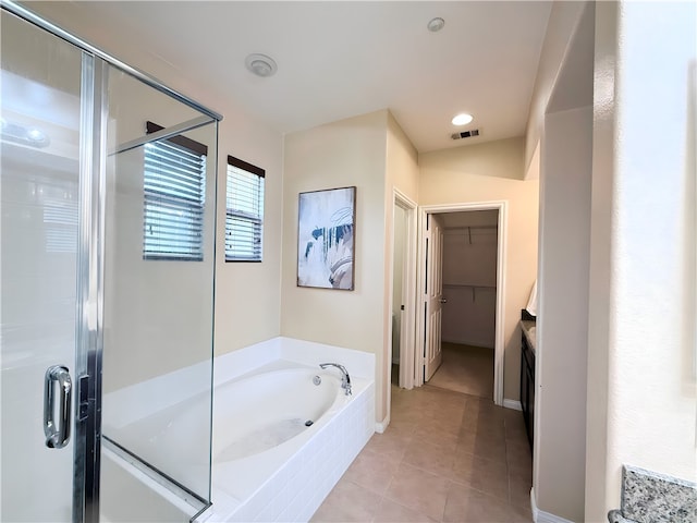 bathroom featuring tile patterned floors and shower with separate bathtub